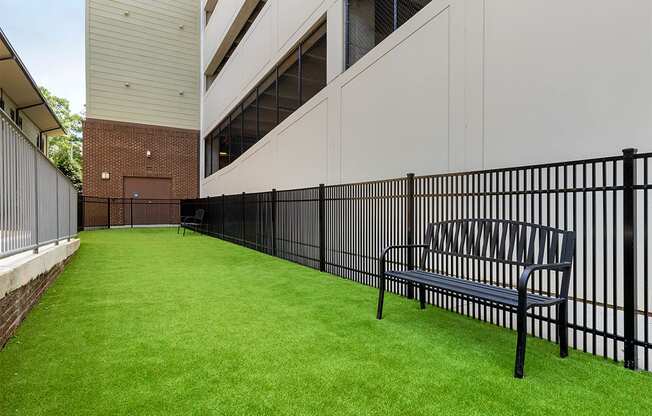 Dog park with bench and turf grass,at 1010 Dilworth Apartments, Charlotte, 28204