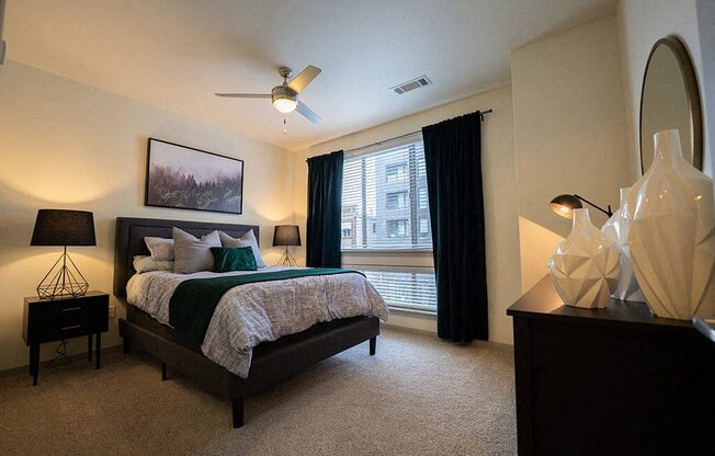 a bedroom with a bed and a ceiling fan