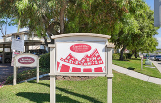 a sign in front of a building with a red and white sign