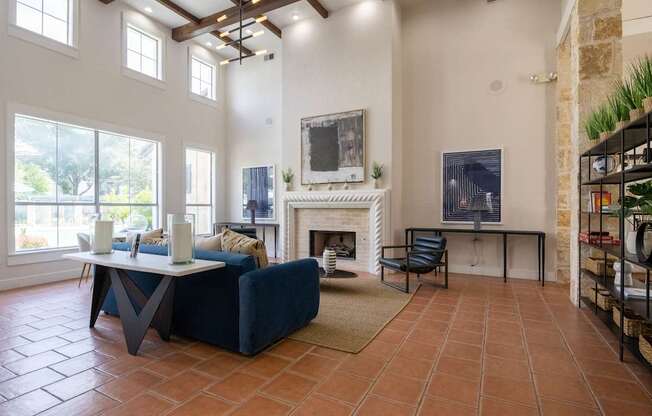 A living room with a fireplace and a painting on the wall.
