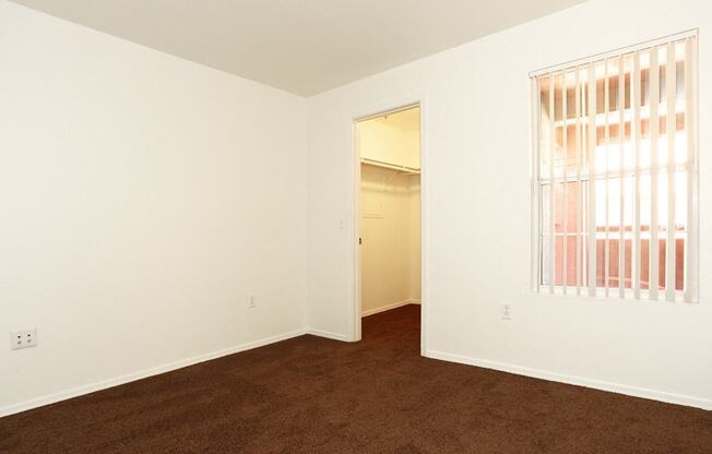 Room with attached closet at San Bellino Apartments, Glendale, AZ, 85303