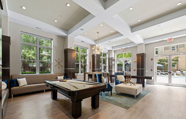 a large living room with a pool table