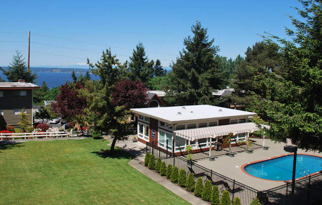 a backyard with a pool and a house with a white roof