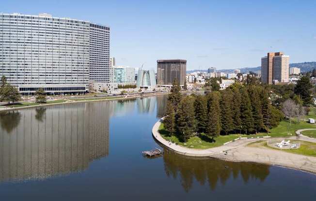 A large building sits next to a body of water with a boat in it.