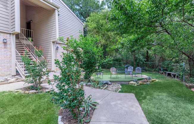 A house with a well-kept garden in front.