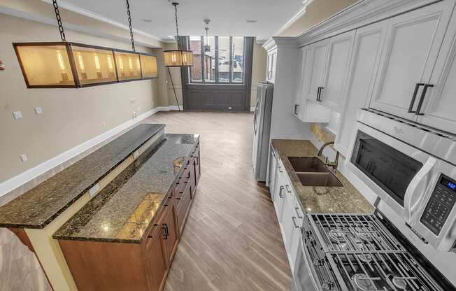 a kitchen with granite counter tops and stainless steel appliances at The Knights @ 506 Delaware Apartments, Buffalo, New York