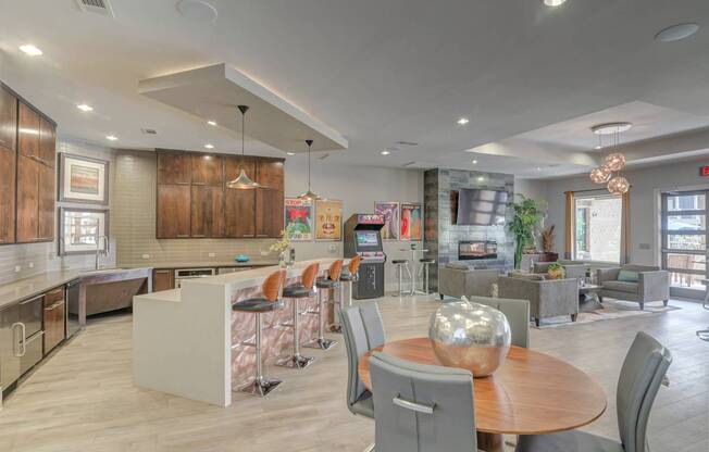 A modern open-concept living space with a kitchen, dining area, and living room.