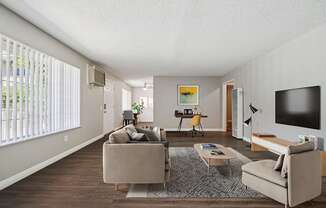 A living room with a couch, chair, and television.