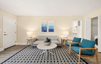 Apartments in Marina Del Rey - Casa De Marina - Living Room With Grey Couch, Diamond Shaped Black & White Area Rug, and Two Wooden Chairs