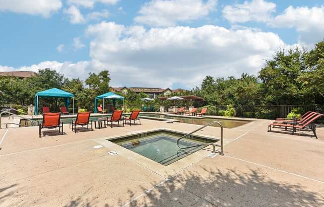 the reserve at the falls pool and hot tub with chairs and umbrellas