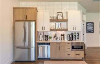 A kitchen with a refrigerator, cabinets, and a tiled backsplash at Timberridge Place Apartment Homes, Oregon, 97322
