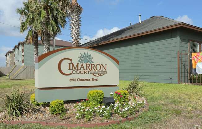 A sign for Cimarron Court with a green background and white lettering.