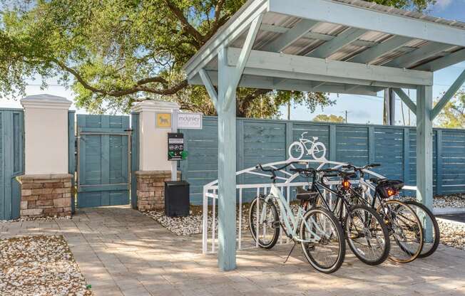 a group of bikes parked under a shed