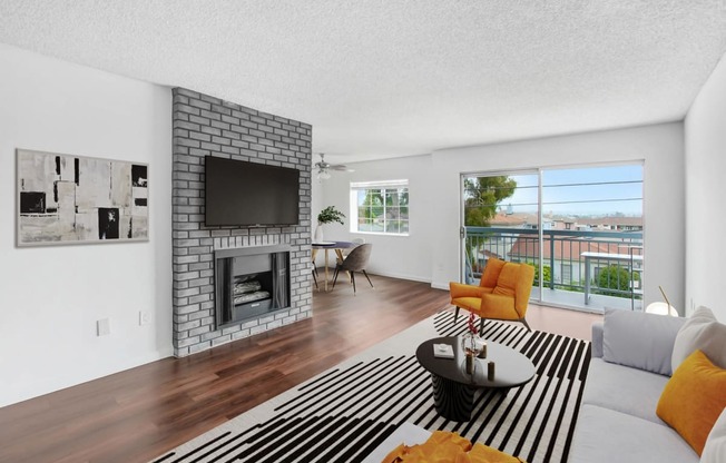 a living room with a fireplace and a striped rug