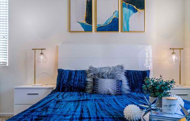 bedroom with carpeted flooring and bed with a blue comforter at Turtle Creek apartments