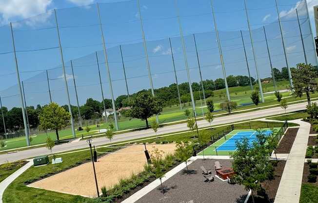 A playground with a blue pool and a fence surrounding it.