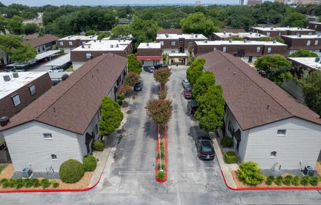 A street view of a residential area with houses on both sides.