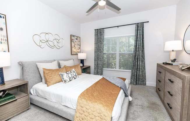 a bedroom with a bed and a ceiling fan