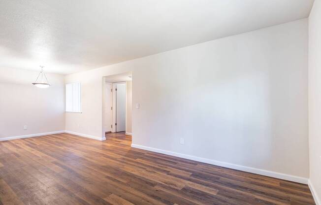 A room with wooden floors and white walls.