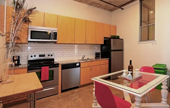 a kitchen with stainless steel appliances and a table