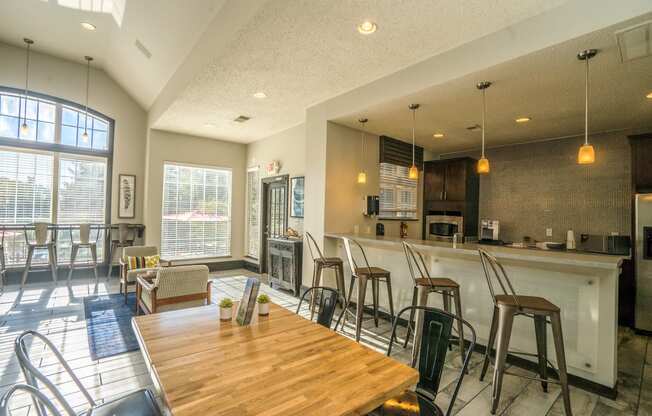 a dining room with a bar and a kitchen with a table and chairs at Radbourne Lake Apartments, Charlotte ? 