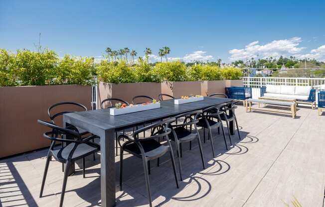 the outdoor dining table on the roof of the home has a view of the city