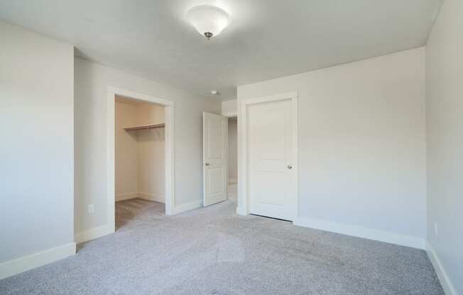 an empty living room with white walls and white doorways at Copper Pines, Bozeman, MT