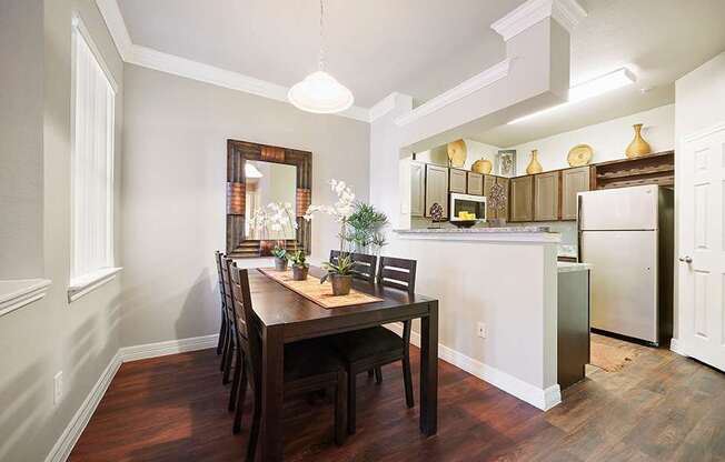 A kitchen with a table and chairs in the middle of the room.
