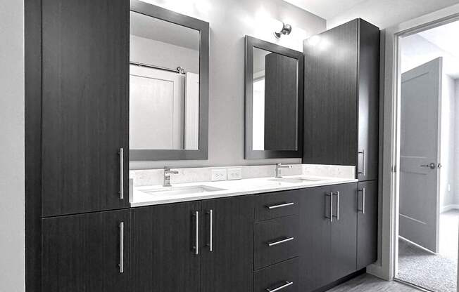 Bathrooms with double vanities, framed mirrors and plenty of storage