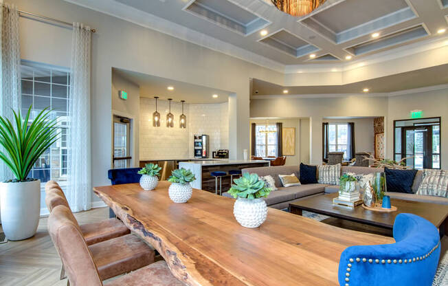 a living room with a long wooden table and blue chairs