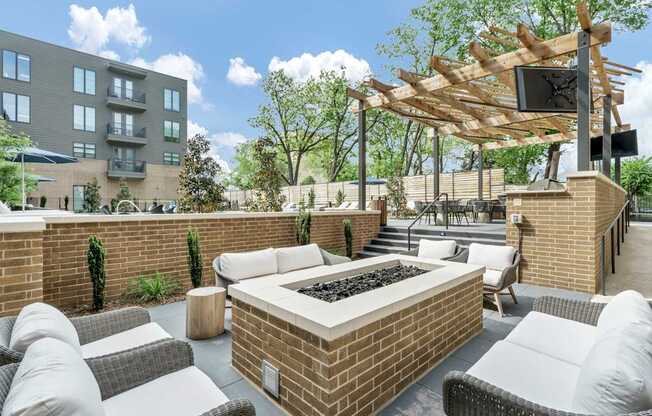 A patio with a fire pit and seating area.