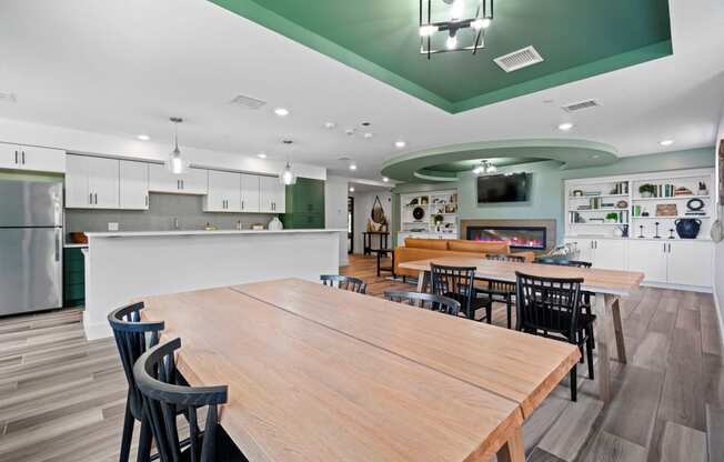 a clubroom kitchen with a large table and chairs at Edgebrook Residences, Merrimack New Hampshire