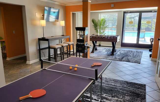 a game room with a ping pong table and a pool table