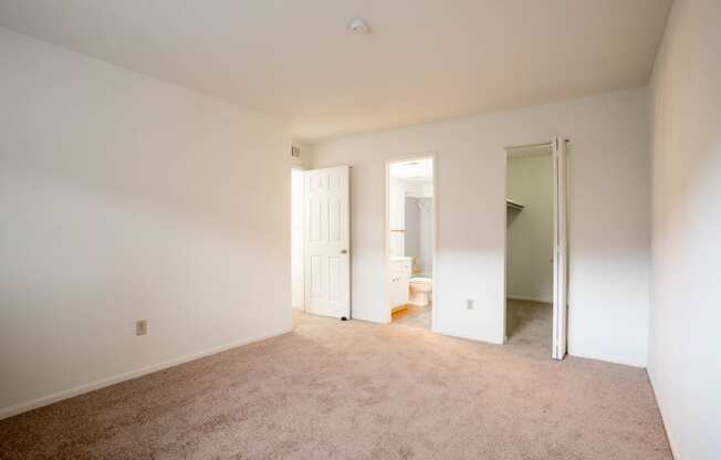 an empty room with a carpeted floor and white walls