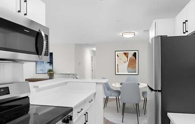 A modern kitchen with a black stove top oven and a black refrigerator.