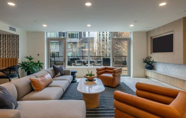 a living room with couches and chairs and a television