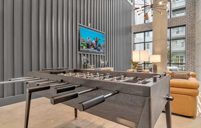 a foosball table in a living room with a couch