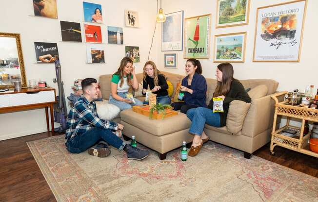 a group of people sitting on a couch in a living room