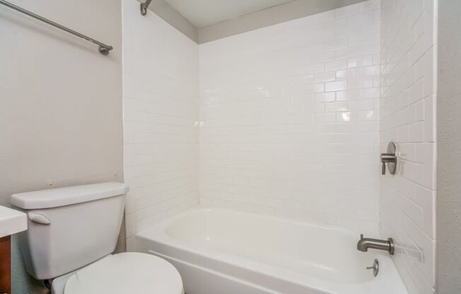 Bright bathroom with tiled tub surround