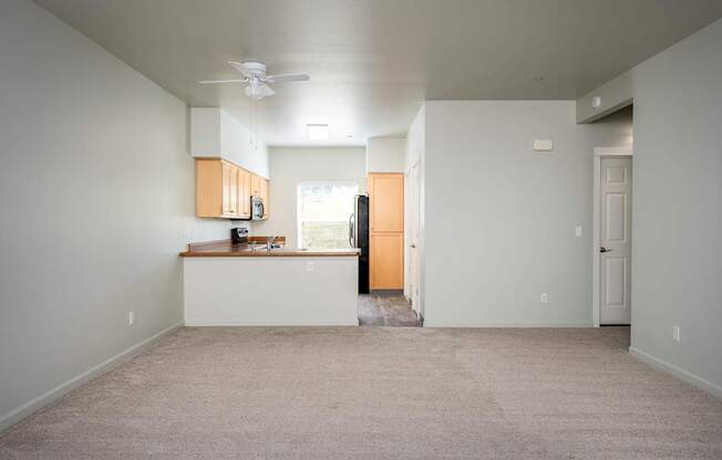 A room with a ceiling fan and a window.