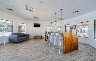 A living room with a grey couch, a wooden table, and a television.