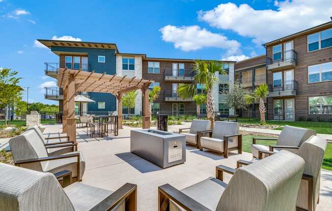 A modern outdoor seating area with a pavilion and chairs.