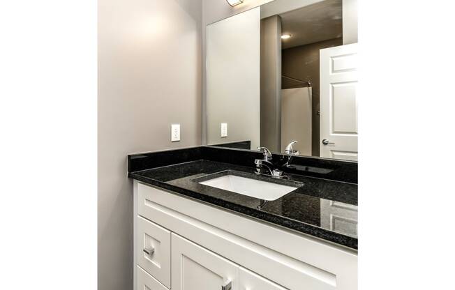 Large bathroom vanity with white cabinets at The Apartments at Lux 96 in Papillion, NE