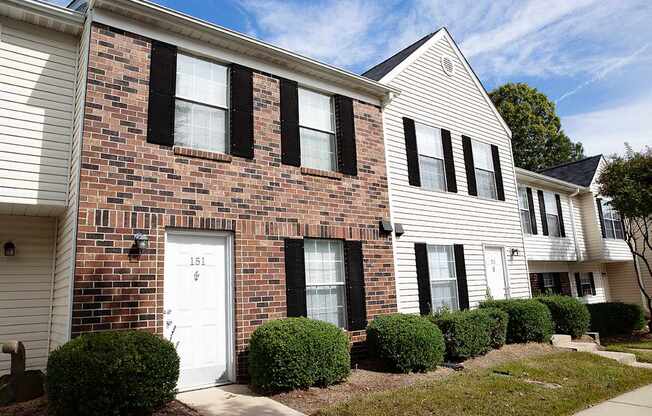 A row of houses with the first one having a white door.