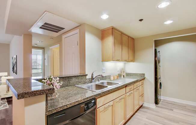 a kitchen with granite counter tops and a sink