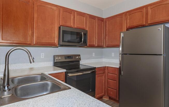 a kitchen with stainless steel appliances and wooden cabinets