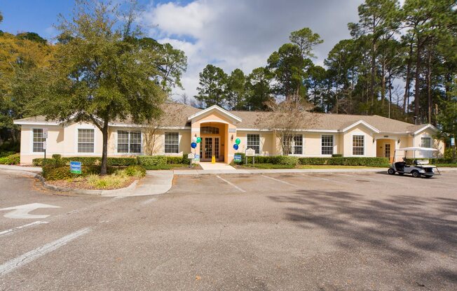 A building with a parking lot in front of it.