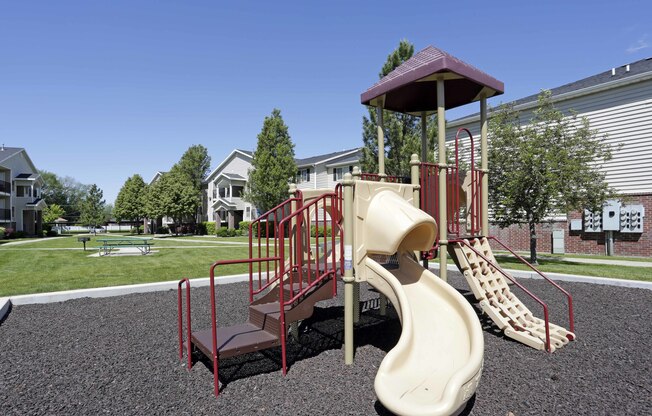 Smaller playground with 3 slides and climbing structure