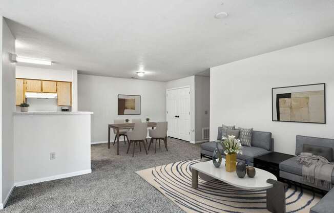 A living room with a grey couch and a coffee table at Arbors at Georgetown Apartments, Michigan