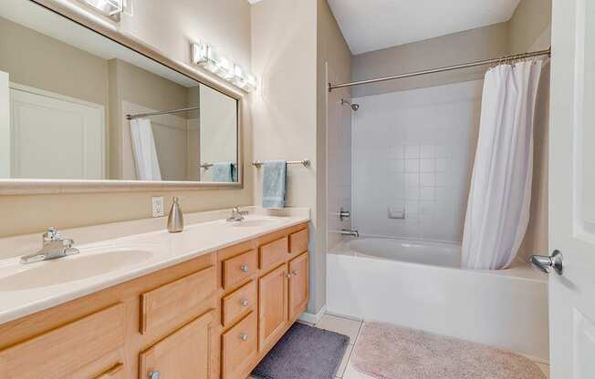 Full bathroom with large mirror and two sinks